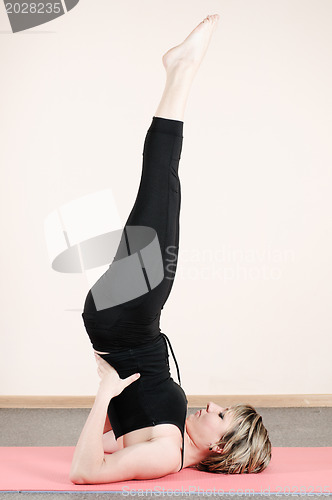 Image of young woman doing yoga exercises