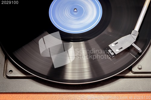 Image of Vintage record player with spinning vinyl. Motion blur image. 