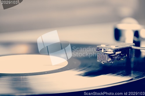 Image of Spinning vinyl record. Motion blur image.  Vintage toned. 