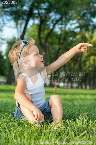 Image of Little boy sitting in the park
