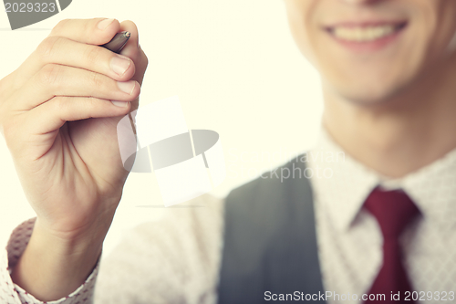 Image of Businessman is writing on a virtual whiteboard