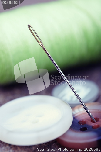 Image of Buttons and sewing needle
