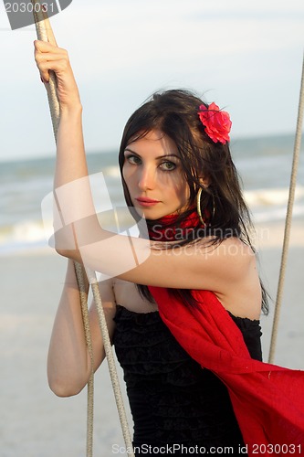 Image of young woman sitting on a swing