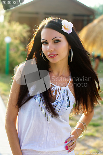 Image of attractive young brunette outdoors