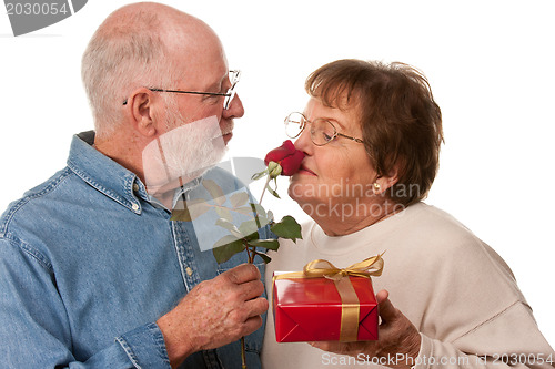 Image of Happy Senior Couple with Gift and Red Rose