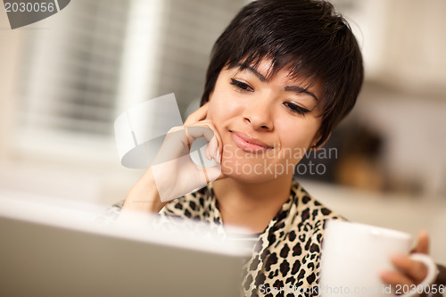 Image of Pretty Smiling Mixed Race Woman Using Laptop