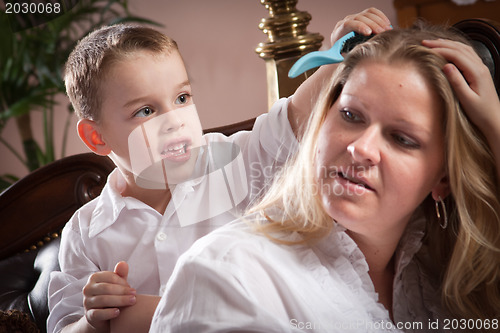 Image of Cute Son Brushing His Mom's Hair