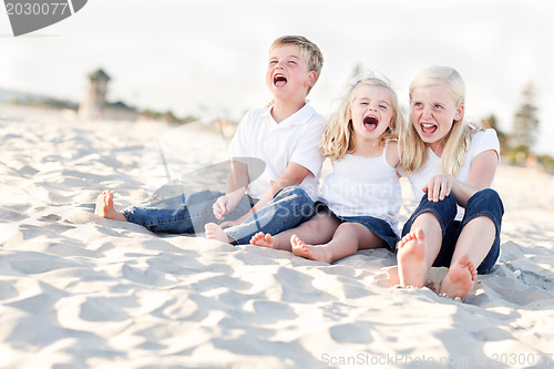 Image of Cute Sibling Children Sitting at the Beach