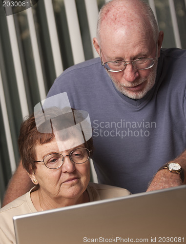 Image of Smiling Senior Adult Couple Having Fun on the Computer
