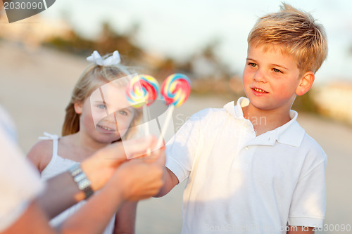 Image of Cute Brother and Sister Picking out Lollipop