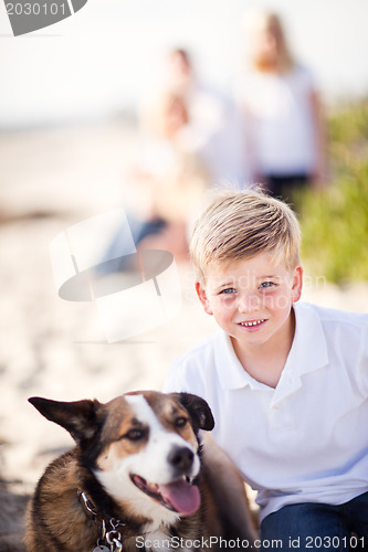 Image of Handsome Young Boy Playing with His Dog