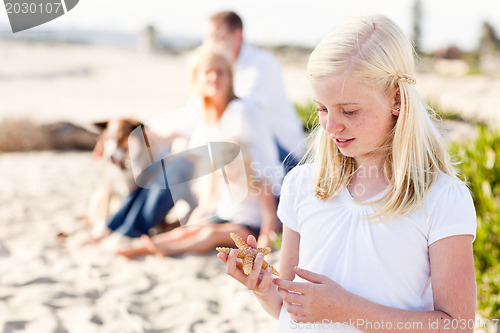 Image of Adorable Little Blonde Girl with Starfish