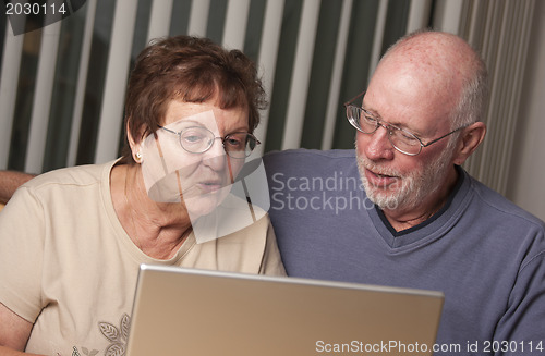 Image of Smiling Senior Adult Couple Having Fun on the Computer