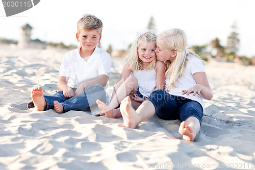 Image of Adorable Sisters and Brother Having Fun at the Beach