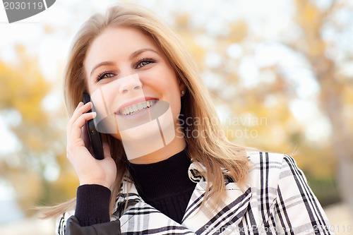 Image of Pretty Young Blond Woman on Phone Outside