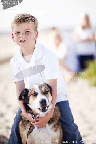 Image of Handsome Young Boy Playing with His Dog