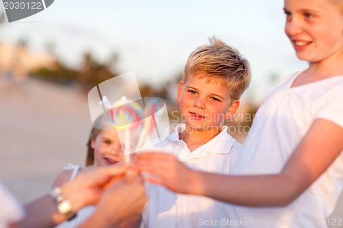 Image of Cute Brother and Sisters Picking out Lollipop