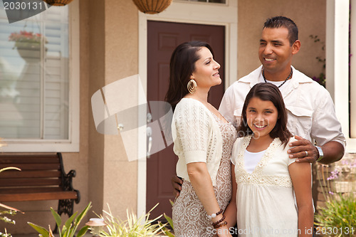 Image of Small Happy Hispanic Family in Front of Their Home