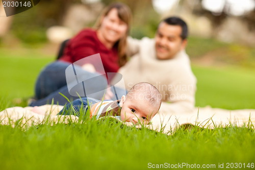 Image of Happy Baby Boy and Mixed Race Parents Playing in the Park