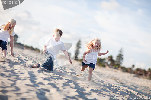 Image of Adorable Brother and Sisters Having Fun at the Beach