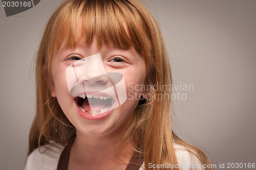Image of Fun Portrait of an Adorable Red Haired Girl on Grey