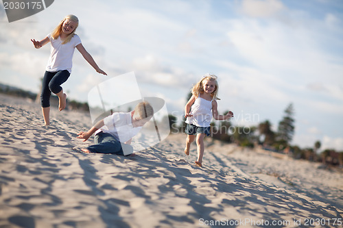 Image of Adorable Brother and Sisters Having Fun at the Beach