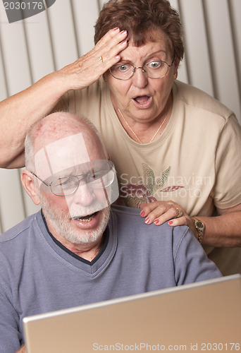 Image of Smiling Senior Adult Couple Having Fun on the Computer