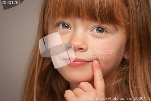 Image of Fun Portrait of an Adorable Red Haired Girl on Grey