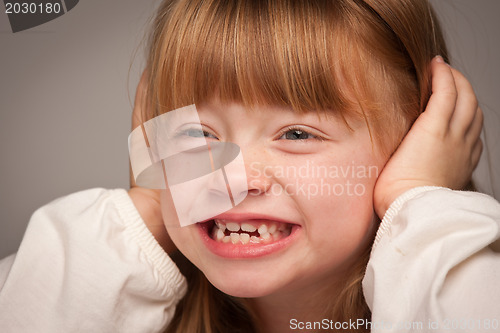 Image of Fun Portrait of an Adorable Red Haired Girl on Grey