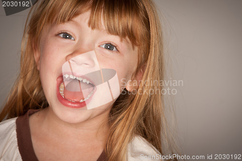 Image of Fun Portrait of an Adorable Red Haired Girl on Grey
