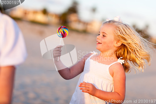 Image of Adorable Little Girl Enjoying Her Lollipop Outside