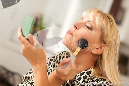Image of Blonde Woman Applying Her Makeup