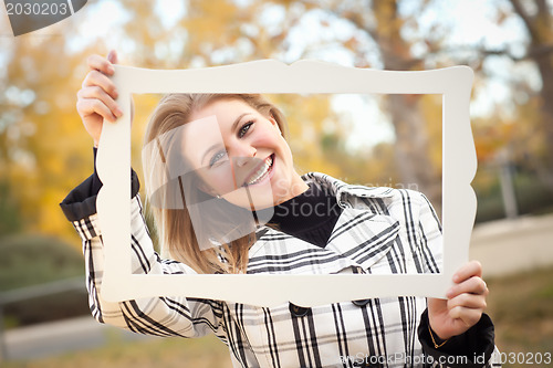 Image of Pretty Young Woman Smiling in the Park with Picture Frame