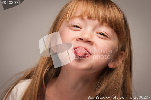 Image of Fun Portrait of an Adorable Red Haired Girl on Grey