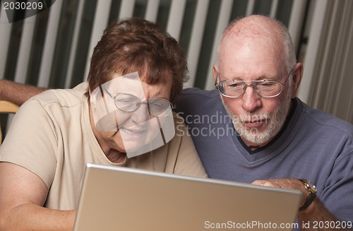 Image of Smiling Senior Adult Couple Having Fun on the Computer