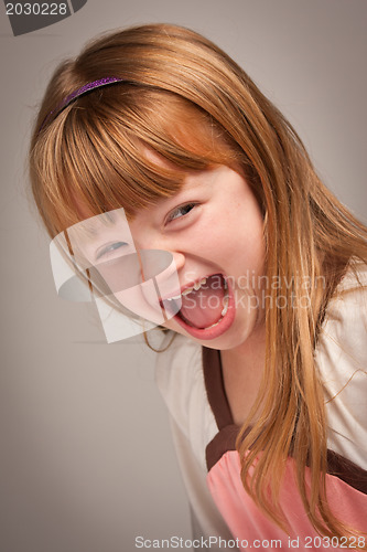 Image of Fun Portrait of an Adorable Red Haired Girl on Grey