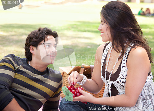 Image of Attractive Hispanic Couple Having a Picnic in the Park