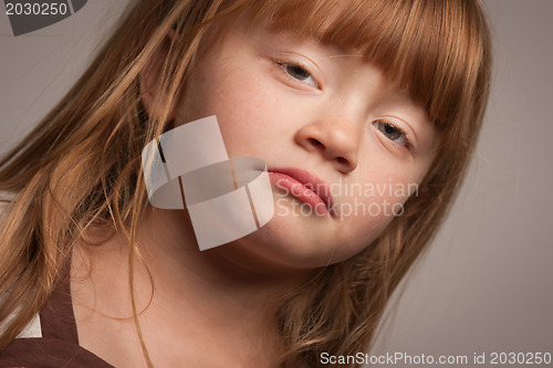 Image of Fun Portrait of an Adorable Red Haired Girl on Grey
