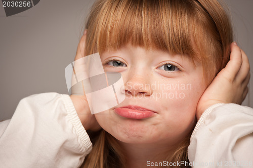 Image of Fun Portrait of an Adorable Red Haired Girl on Grey
