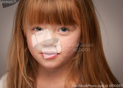 Image of Fun Portrait of an Adorable Red Haired Girl on Grey