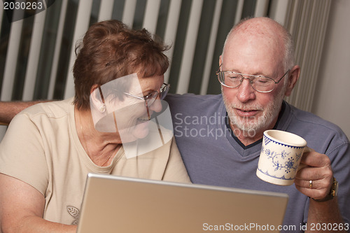 Image of Smiling Senior Adult Couple Having Fun on the Computer