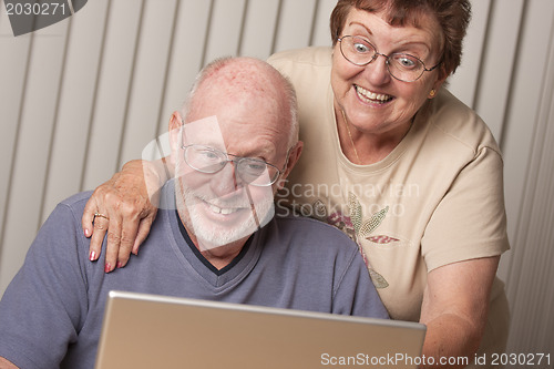 Image of Smiling Senior Adult Couple Having Fun on the Computer