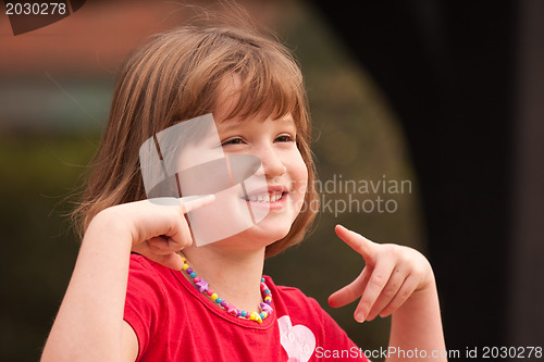 Image of Adorable Girl Poses While Playing