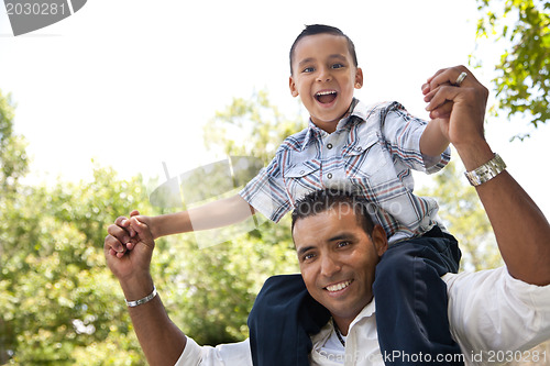 Image of Hispanic Father and Son Having Fun in the Park