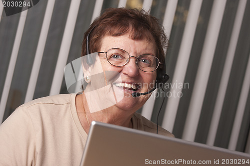 Image of Smiling Senior Adult Woman with Telephone Headset and Monitor