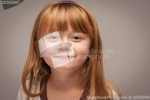 Image of Fun Portrait of an Adorable Red Haired Girl on Grey