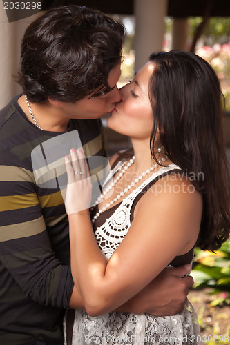 Image of Attractive Hispanic Couple Kissing Outdoors