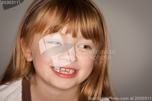 Image of Fun Portrait of an Adorable Red Haired Girl on Grey