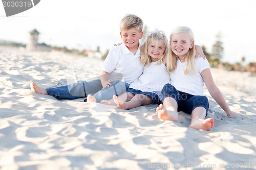 Image of Adorable Sisters and Brother Having Fun at the Beach