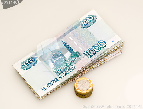 Image of A bundle of money and a stack of coins 